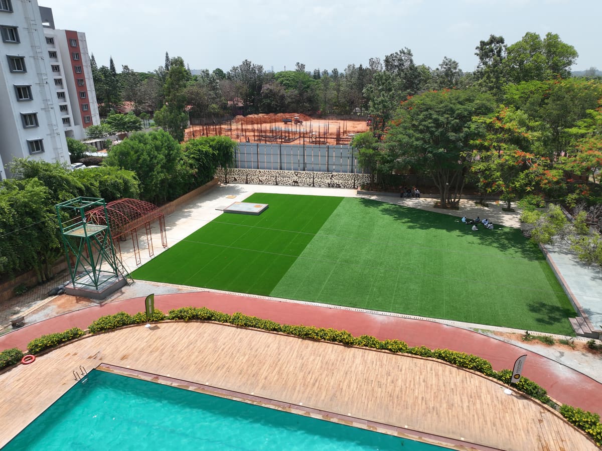 Aerial or elevated view of the whole campus showing the pool, main lawn, banquet hall and room blocks in one frame