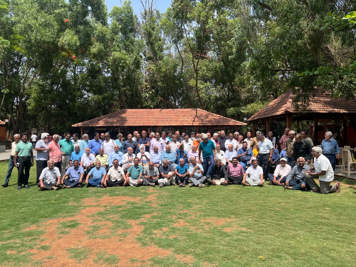 Group photograph of a full team on the main lawn at the end of an offsite day