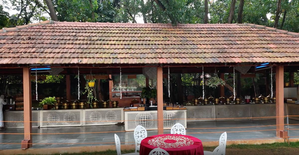 Buffet counters being laid out before lunch service, with chafing dishes and a live counter
