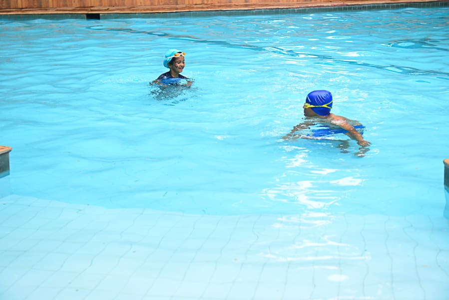 Guests in the water of the main pool on a Sunday afternoon