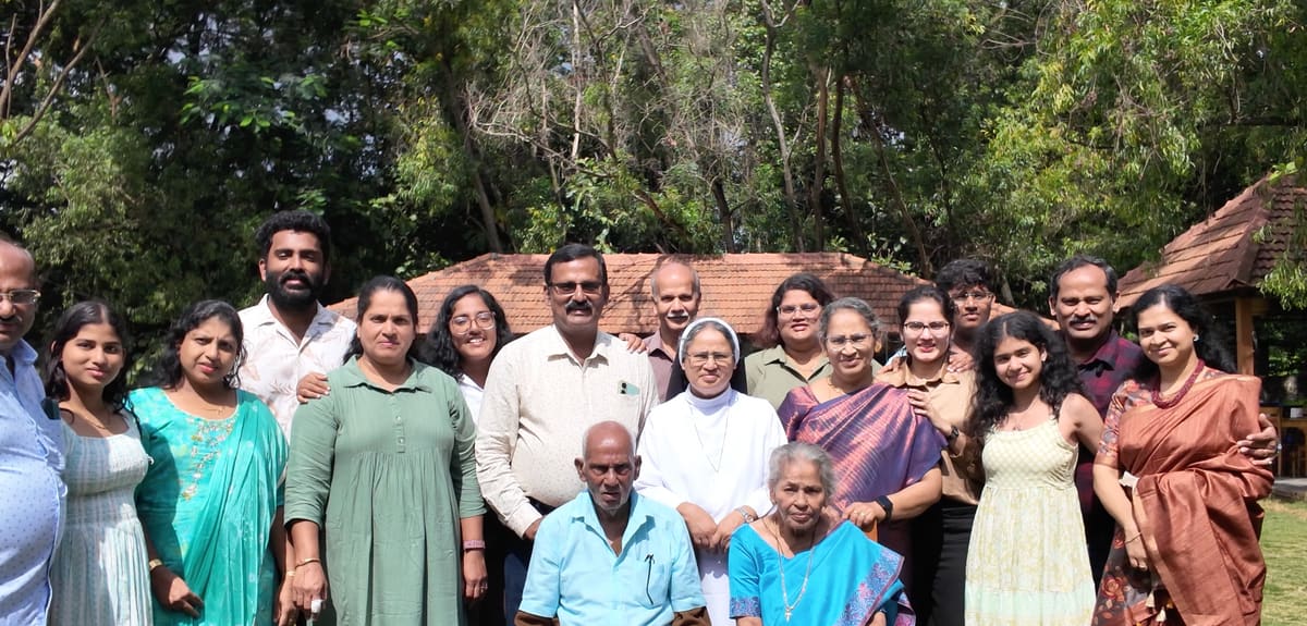 Large extended family group photograph on the lawn at the end of the day