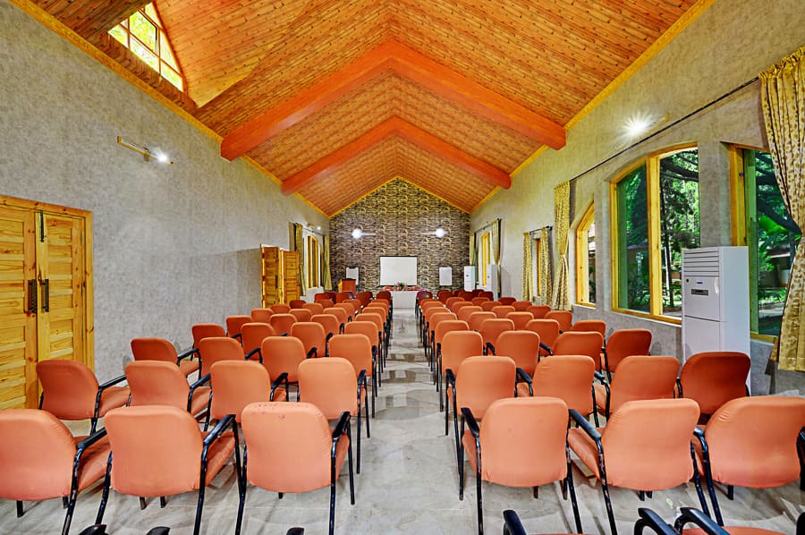 Banquet hall in theatre seating for a town hall with the projector screen at the front