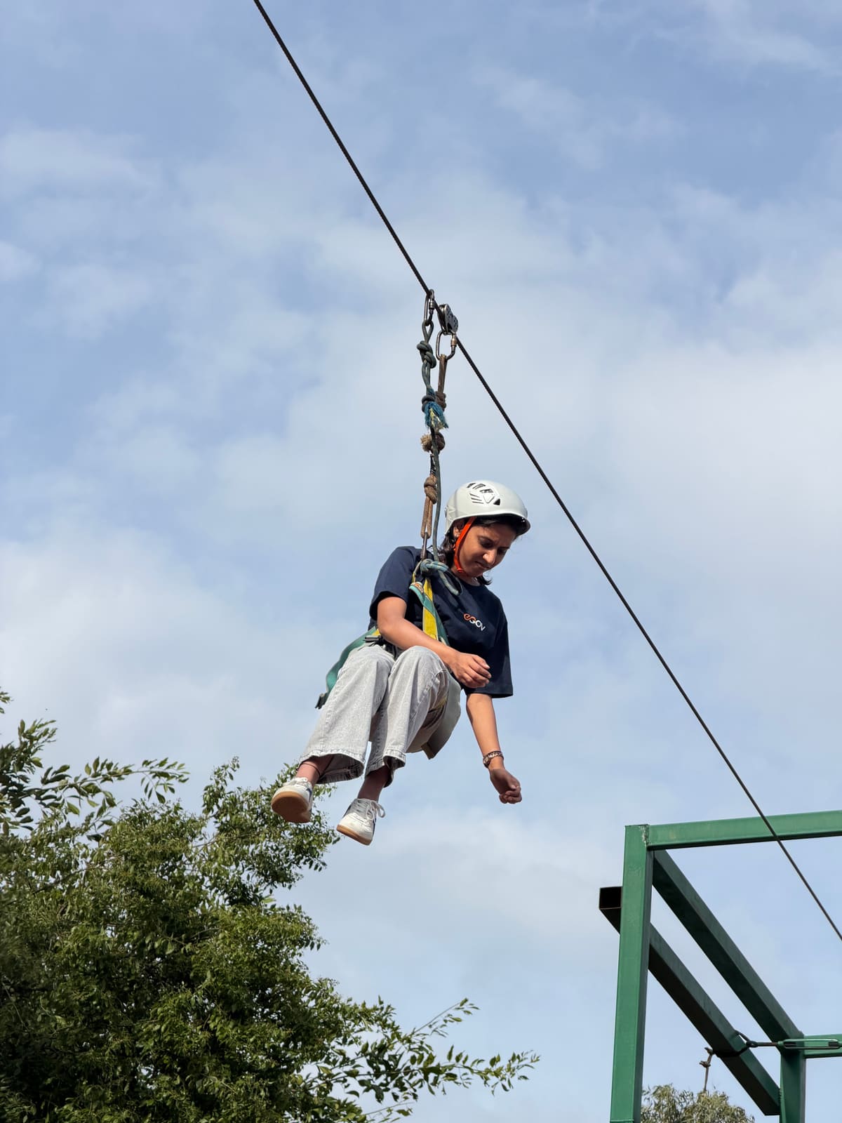 A guest crossing the resort on the zipline in the adventure zone
