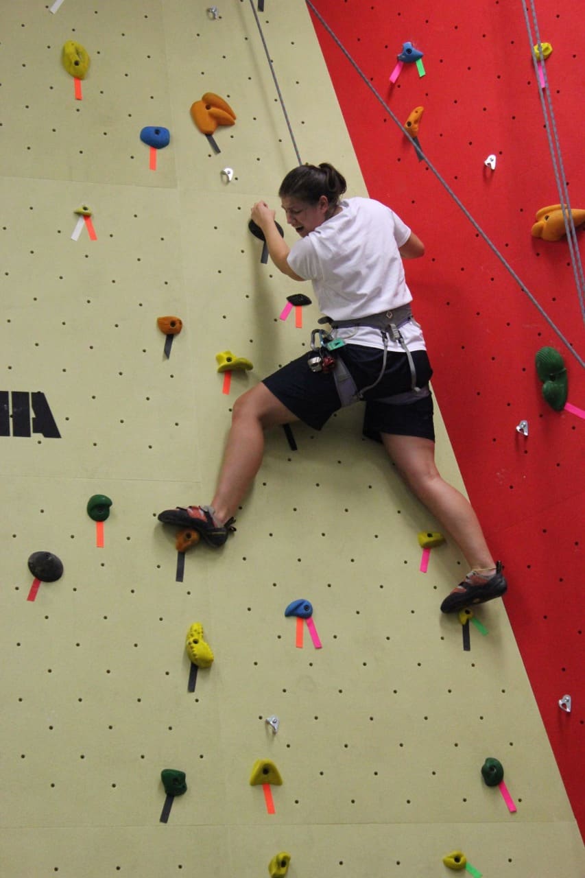 The rock climbing wall in the adventure zone with a guest near the top
