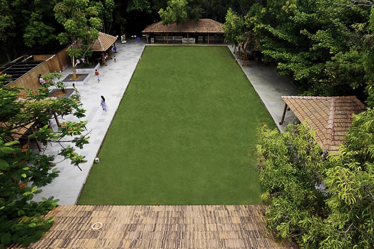 Wide view across the main lawn towards the banquet hall in late afternoon light