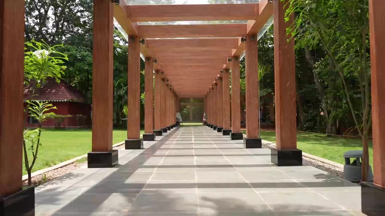 The pillared walkway opening onto the wedding lawn at Gold Coins Club & Resort