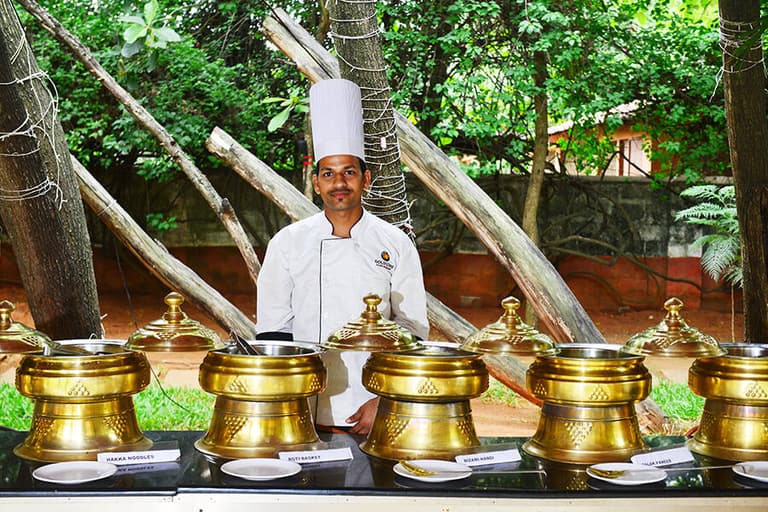 Chef at the Sunday brunch live counters with brass chafing dishes at Gold Coins Club & Resort