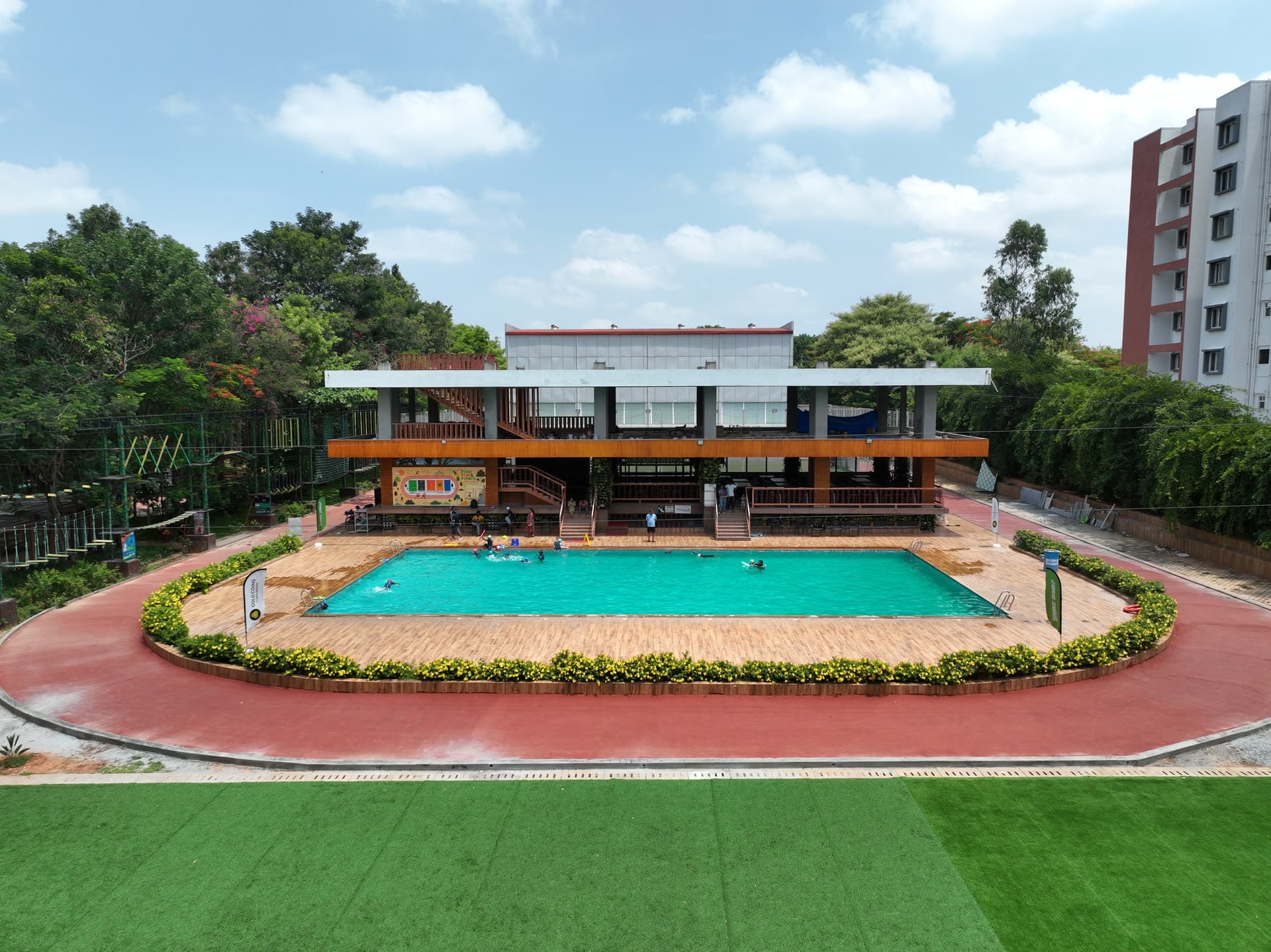 The swimming pool and clubhouse from above, a birthday party venue at Gold Coins Club & Resort