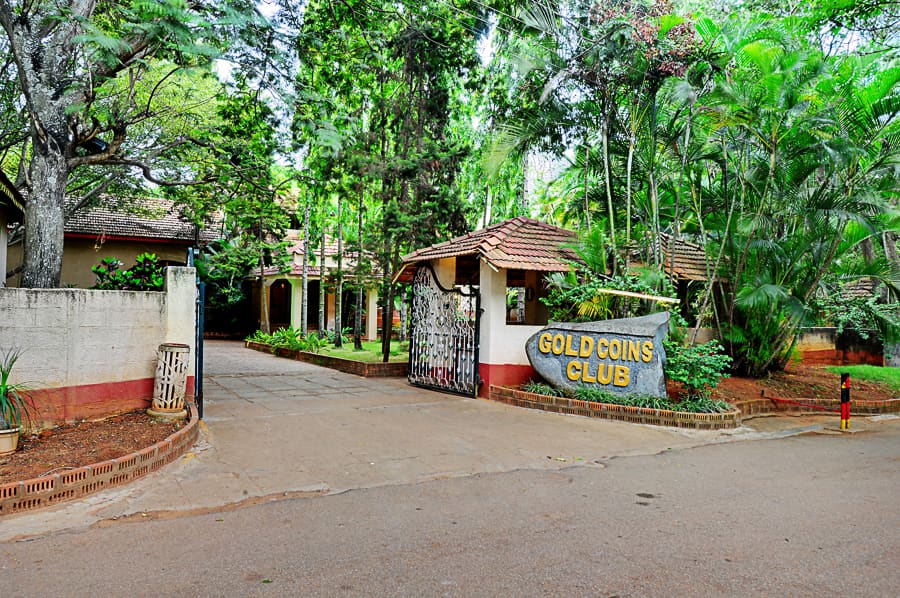 The Gold Coins Club entrance gate off Huskur Road at Andapura