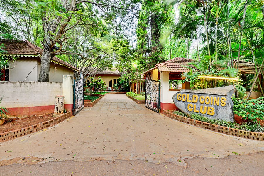 The Gold Coins Club entrance gate off Huskur Road at Andapura
