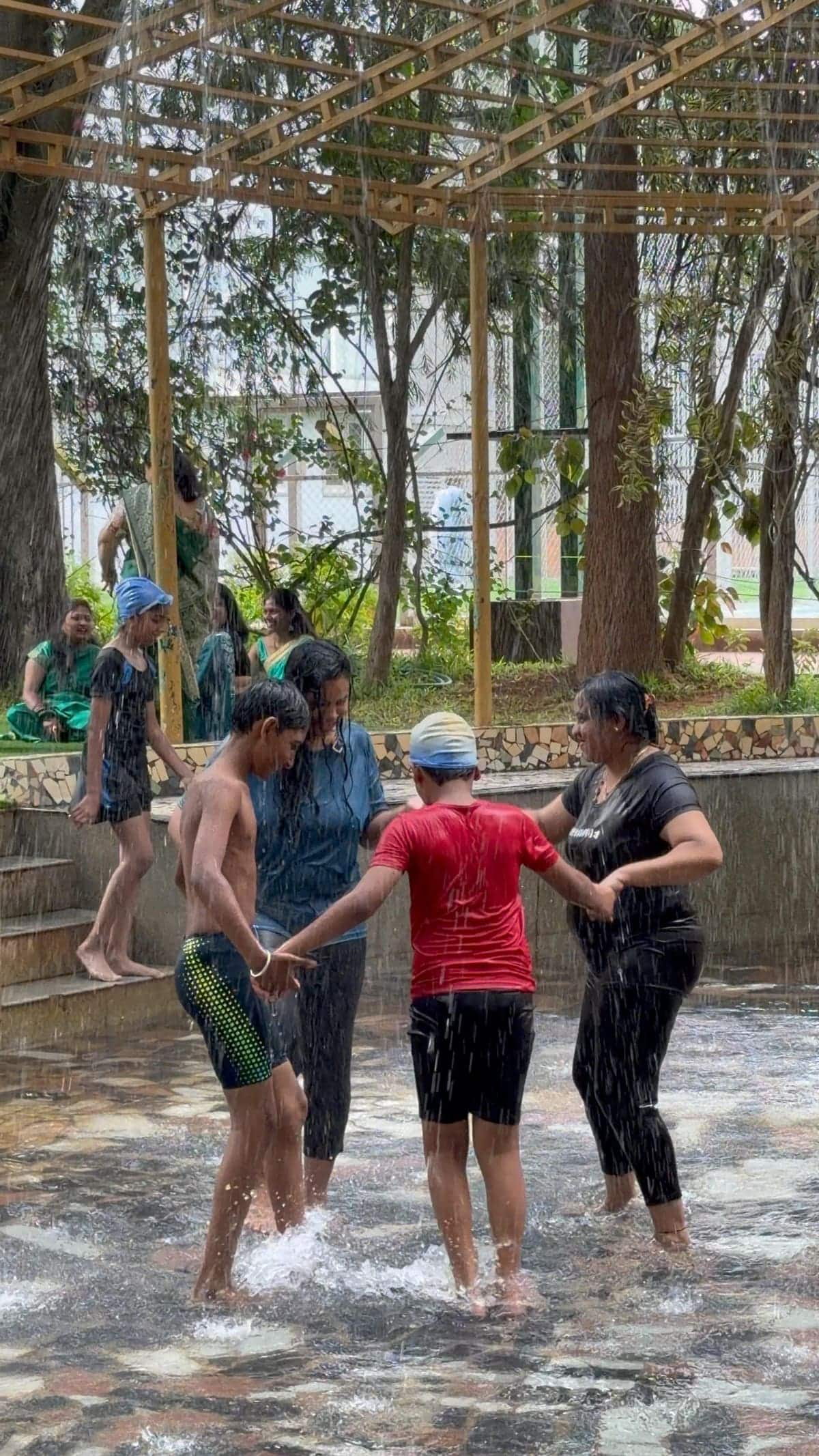 Guests in the pool and at the rain dance on a busy Sunday
