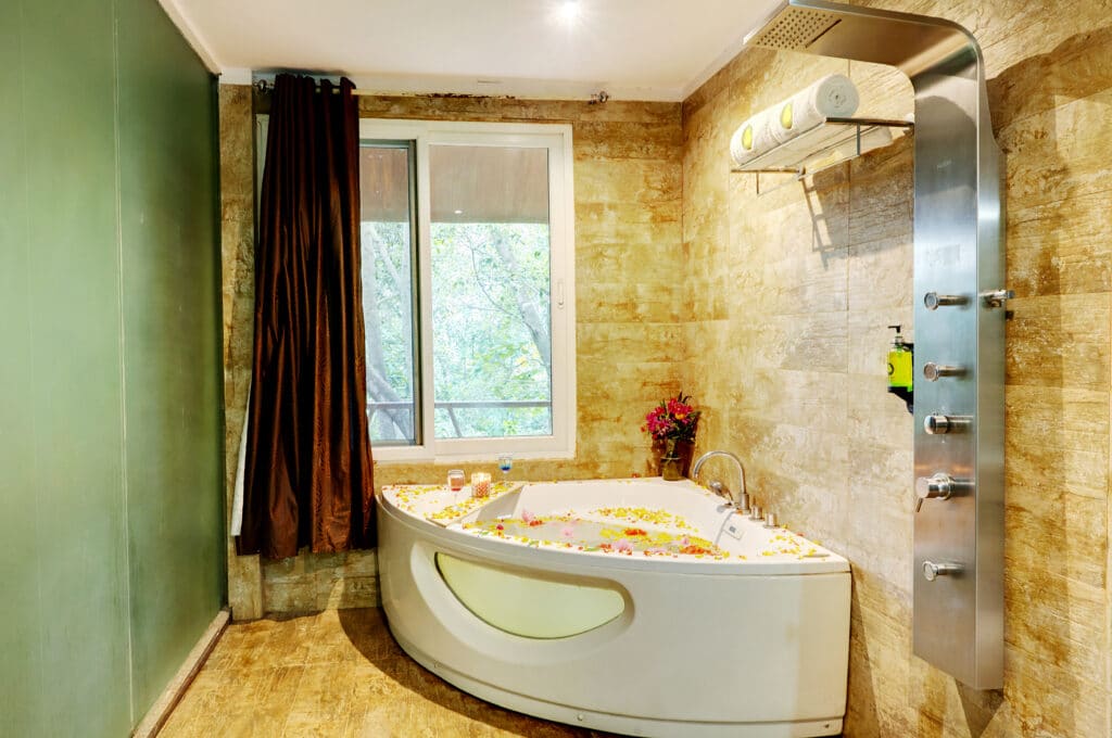 Sky Room bathroom, shower running hot, towels and toiletries laid out on the counter