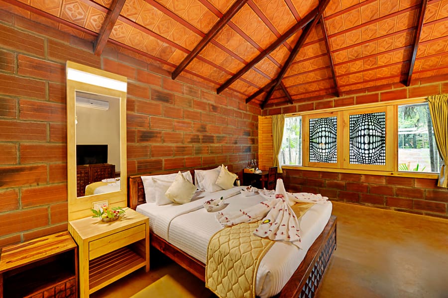The suite king bed with the doors to the private pool open behind it