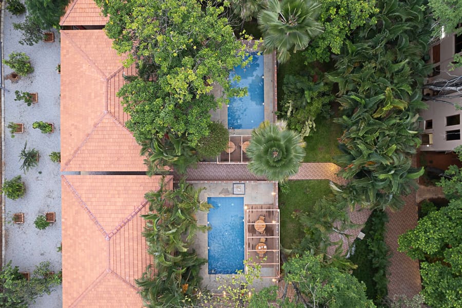 Wide shot of the whole suite and its private pool from the garden side