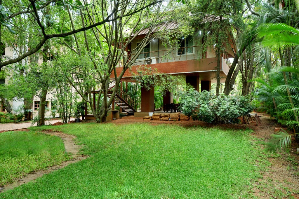 Morning on the grounds with the room block among the trees