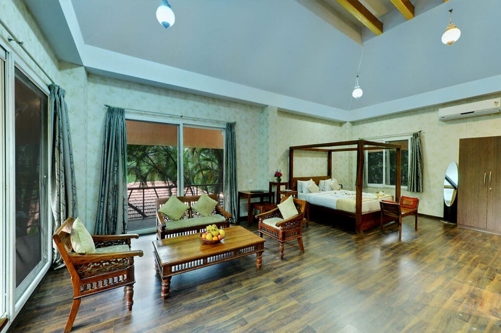 The Sky Room from the doorway, king bed made up, daylight through the upper-floor window