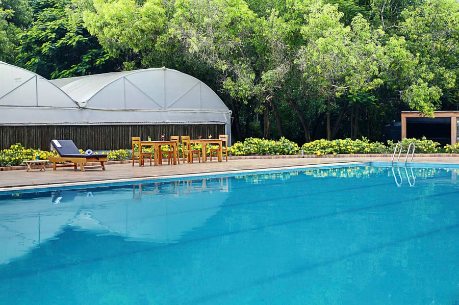The poolside deck with loungers, ready for a cocktail evening