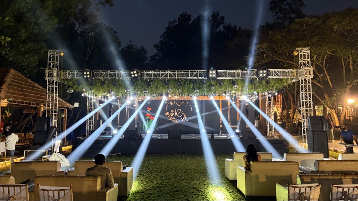 Sangeet night with the stage, dance floor and lighting on the lawn